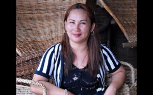 Milagros proudly showcasing the most popular products from her rattan handicrafts portfolio.