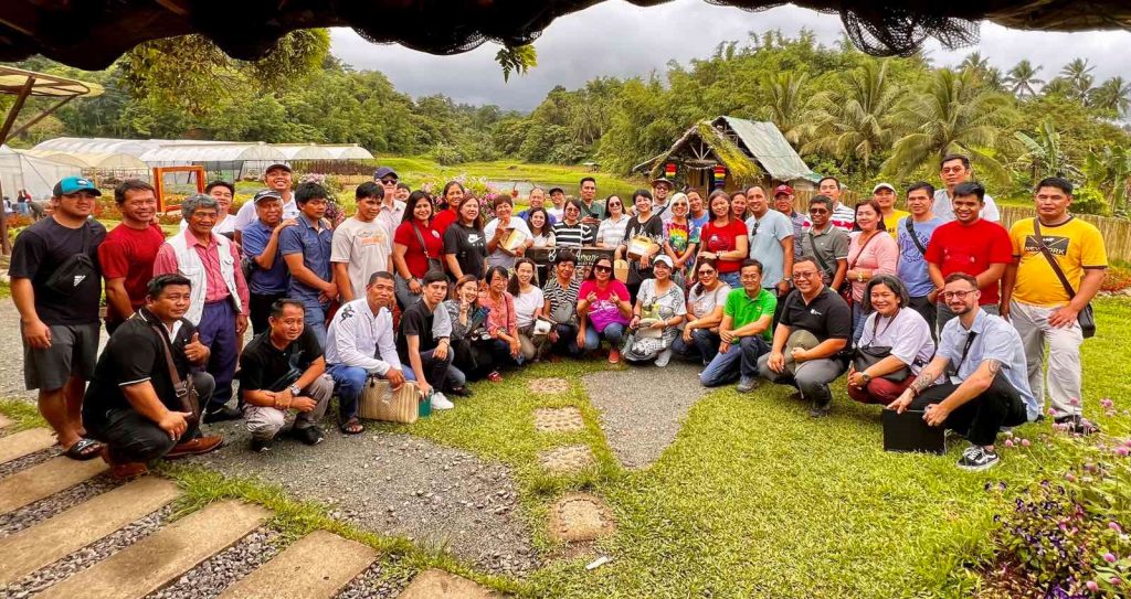 Selected farmer clients, board members, and staff of Bangko Kabayan and RPMI with the MCPI GIF Team in one of the farms they visited